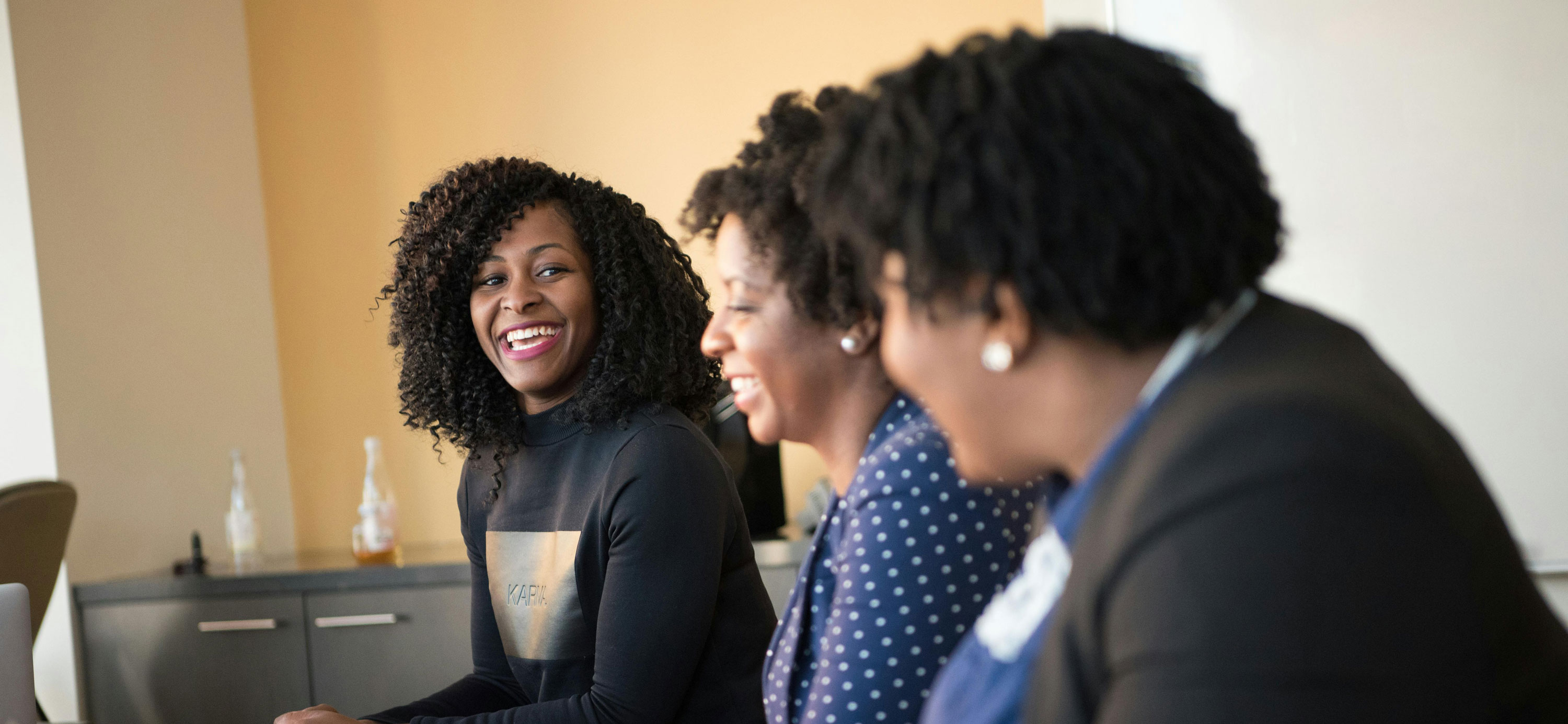Women smiling at business meeting